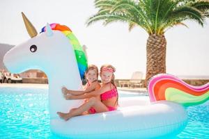 Two little kids playing in the swimming pool photo