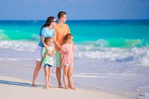 Beautiful family have a lot of fun on the beach photo
