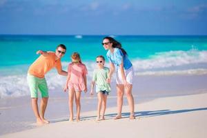 Happy beautiful family on a tropical beach photo