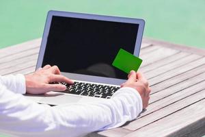 Close-up of computer and credit card on the table photo