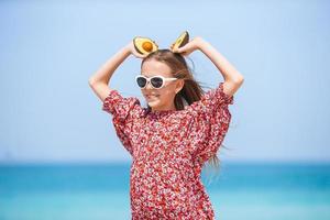 Cute little girl at beach during summer vacation photo