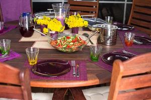 Beautiful home served table for dinner on the veranda photo