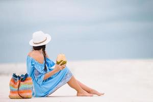 Woman laying on the beach enjoying summer holidays looking at the sea photo