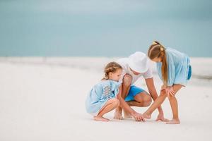 Father and kids enjoying beach summer vacation photo