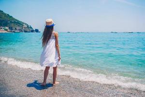 Cute little girl at beach during summer vacation photo