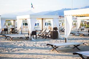 Sunbeds and loungers on european sand beach photo