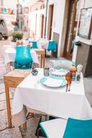 Summer empty outdoor cafe in a tourist place in Italy photo