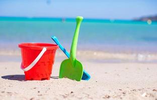 Summer kid's beach toys in the white sandy beach photo