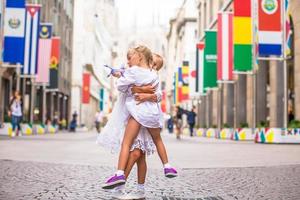 Little adorable girls walking in Milan on italian vacation photo