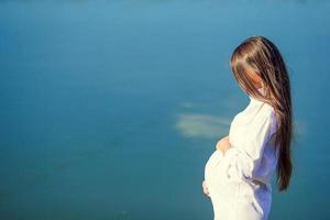 Pregnant woman in outdoor park, warm weather photo