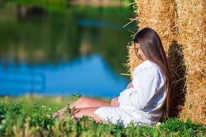 Pregnant woman in outdoor park, warm weather photo