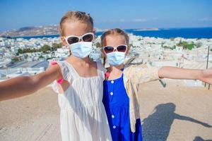 Two girls in dresses in old Mykonos photo