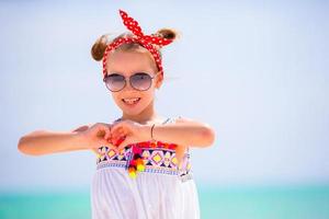 Adorable little girl enjoy beach summer vacation photo