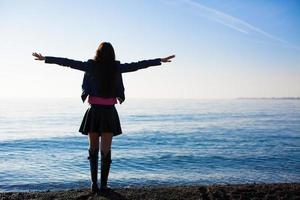 Young woman have fun on winter beach vacation photo