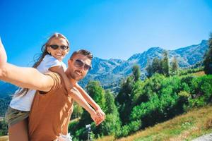 Beautiful happy family in mountains in the background of fog photo