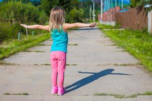 Little girl walking outdoor and having fun photo