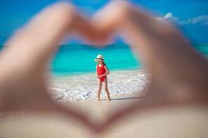 Close up of heart made by female hands background little girl photo