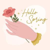 banner de primavera con mano femenina sosteniendo flor y letras dibujadas a mano hola primavera vector