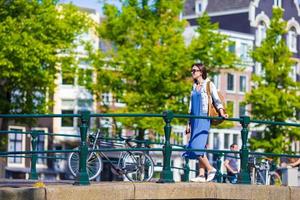 Young caucasian girl enjoy european vacation in Amsterdam, Holland photo