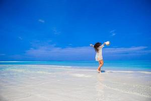 Young beautiful woman on beach during tropical vacation photo