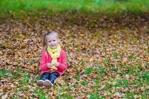 Adorable little girl outdoors at beautiful autumn day photo