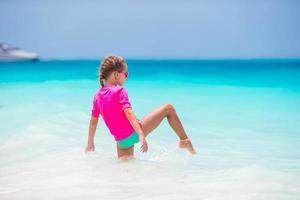 Adorable little girl during beach vacation having fun photo