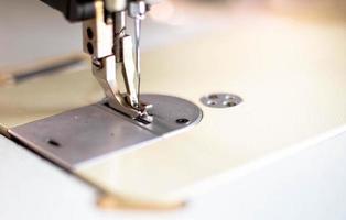 Closeup the sewing machine and thread item at the old sewing machine with vintage style. photo