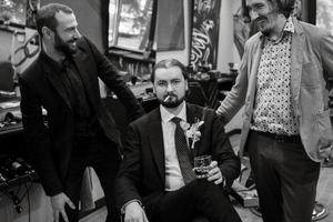 portrait of a male groom in a blue suit in the morning  barbershop photo