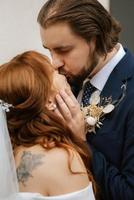 young couple bride and groom in a white dress photo