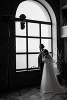 young couple bride and groom in a white dress photo