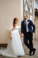 young couple bride and groom in a white dress photo