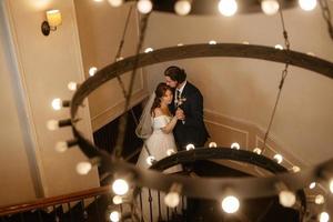 young couple bride and groom in a white dress photo