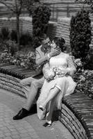 bride in a light wedding dress to the groom in a blue suit photo