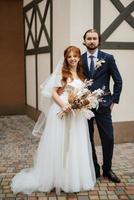 young couple bride and groom in a white dress photo