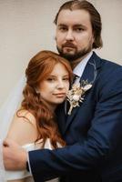 young couple bride and groom in a white dress photo