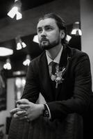 portrait of a male groom in a blue suit in the morning  barbershop photo