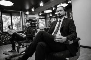 portrait of a male groom in a blue suit in the morning  barbershop photo