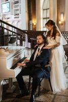 young couple bride and groom in a white dress photo