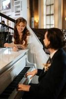 young couple bride and groom in a white dress photo