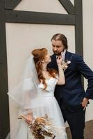 young couple bride and groom in a white dress photo