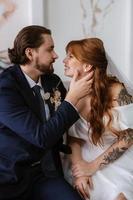 young couple bride and groom in a white dress photo