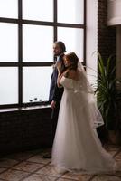 young couple bride and groom in a white dress photo