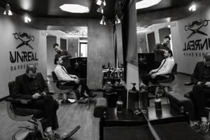 bearded man cutting his beard in the barbershop photo