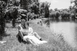 bride in a light wedding dress to the groom in a blue suit photo