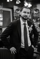 portrait of a male groom in a blue suit in the morning  barbershop photo