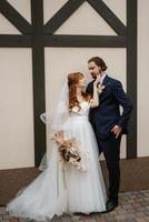 young couple bride and groom in a white dress photo