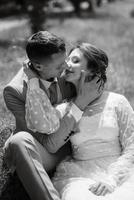 bride in a light wedding dress to the groom in a blue suit photo