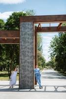 bride in a light wedding dress to the groom in a blue suit photo