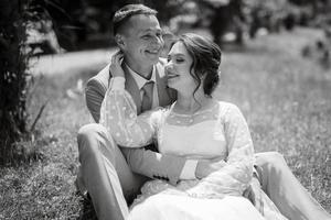 bride in a light wedding dress to the groom in a blue suit photo