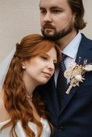 young couple bride and groom in a white dress photo